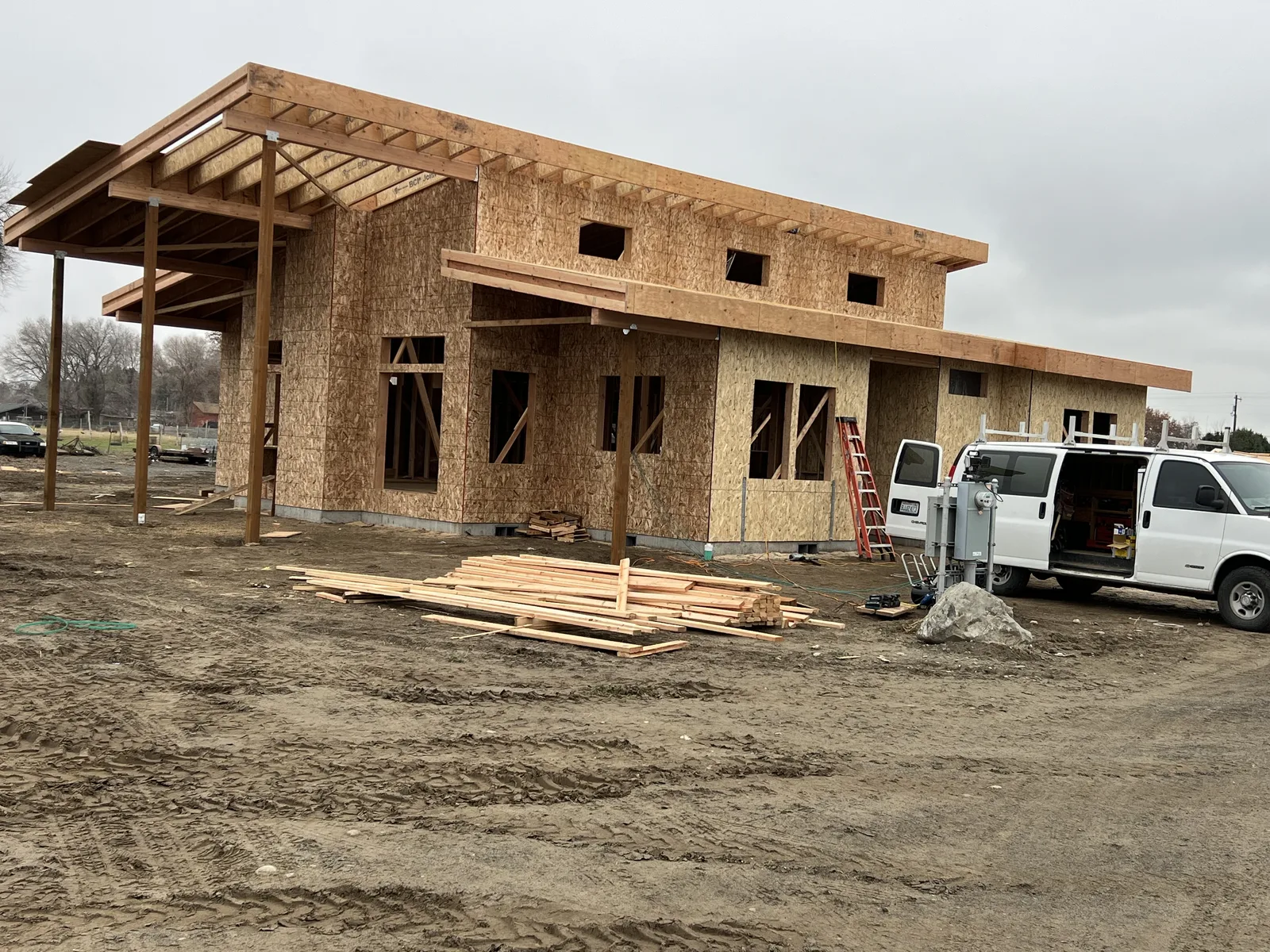 Modern custom home framing with covered porch posts and clerestory window openings