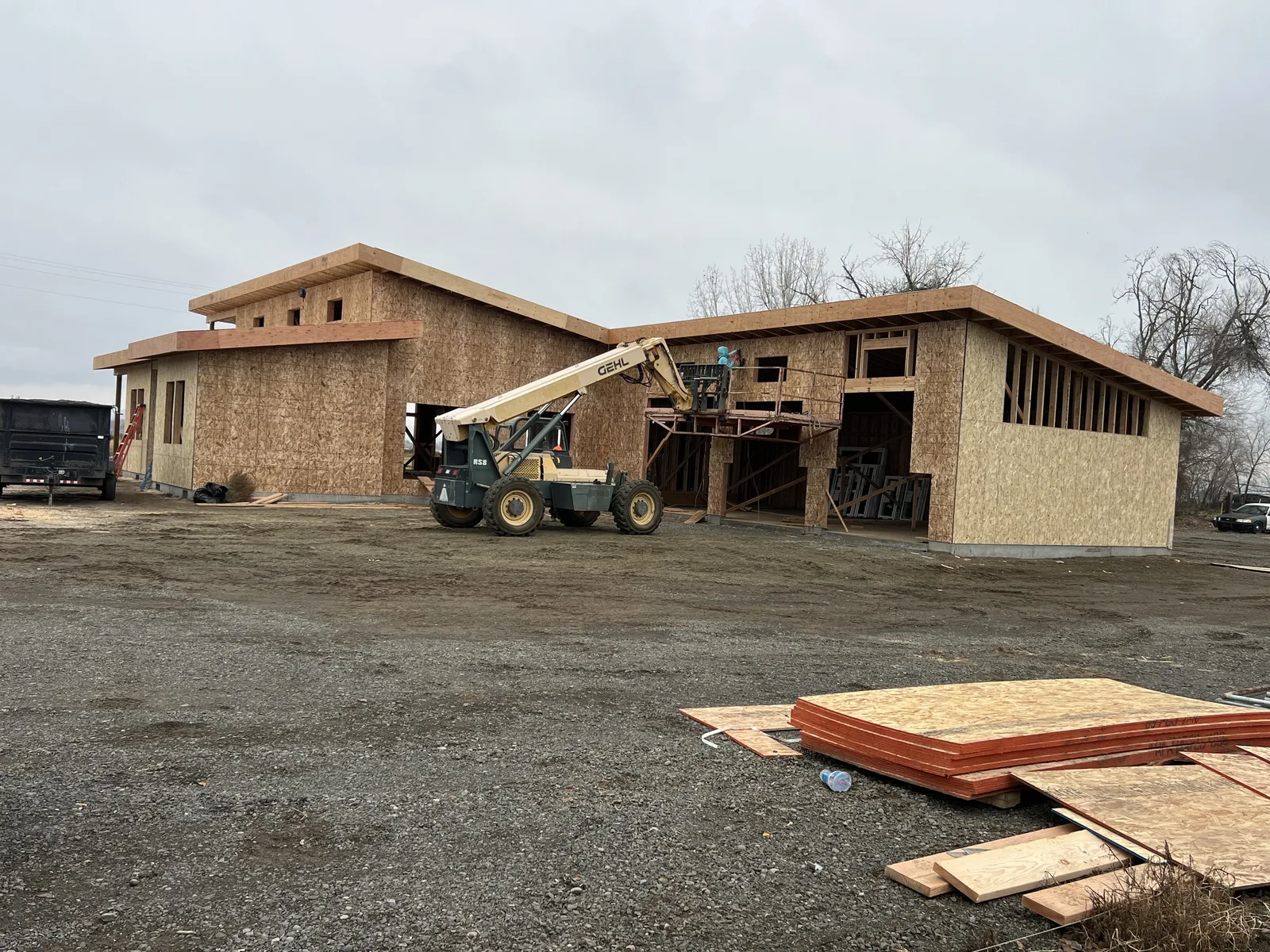 Wall framing and OSB sheathing on a modern custom home with electrical meter installed